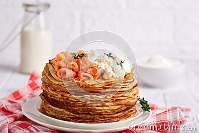 Thin crepe pancakes with salmon fish, cream cheese and thyme. Crepe week. Stock Photo