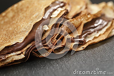 Thin crepes or blinis with chocolate cream on Stock Photo