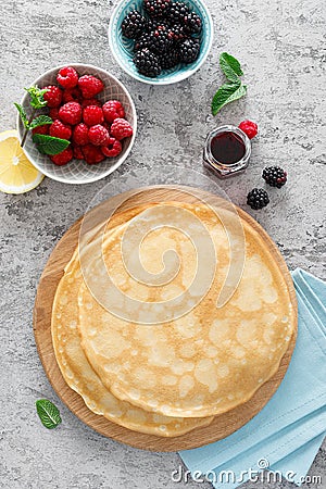 Thin crepes with fresh berries and lemon zest. Pancakes with raspberry and blackberry Stock Photo