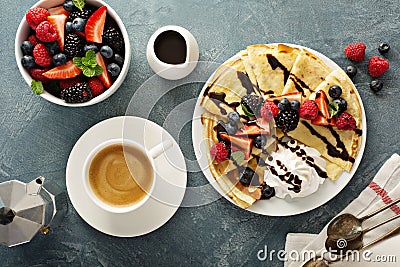 Thin crepes with whipped cream and berries Stock Photo