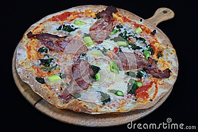 Thin crust Florentine pizza with bacon and spinach Stock Photo