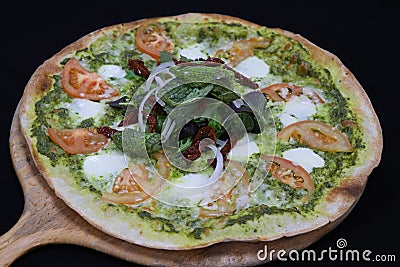 Thin crust Italian pizza with basil pesto sauce Stock Photo