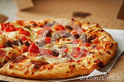 Thin crust Pizza, close up photo of a delicious pizza with mozzarella cheese, onions, meat, tomato Stock Photo