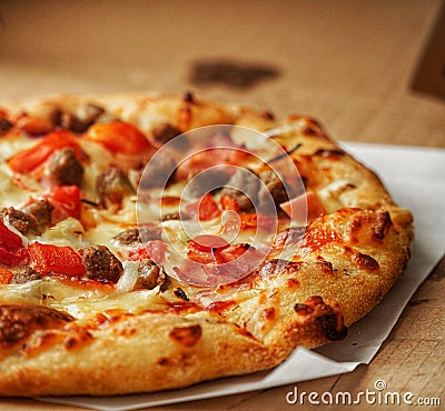 Thin crust Pizza, close up photo of a delicious pizza with mozzarella cheese, onions, meat, tomato Stock Photo