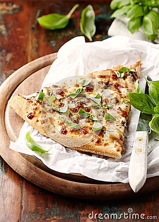 Thin-crust pizza topped with fresh basil leaves. Slice of pizza. Home made food. Italian vegetarian pizz Stock Photo