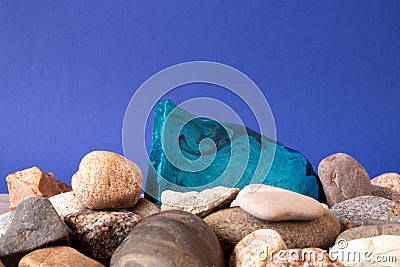 Thin flat piece of blue mint handmade soap lying on a pile of pebble Stock Photo