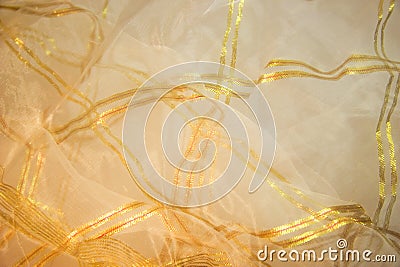 Thin mesh fabric with a gold pattern Stock Photo