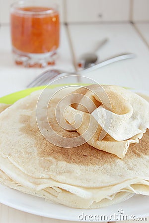 Thin pancakes, apricot jam in a glass Stock Photo
