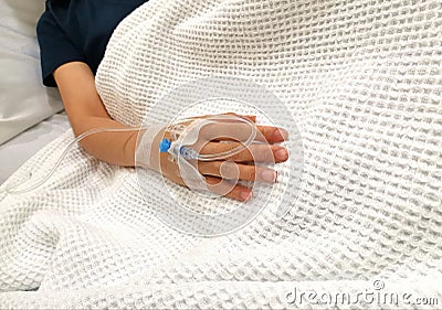 Drip tube inserted in right arm of patient in hospital Stock Photo
