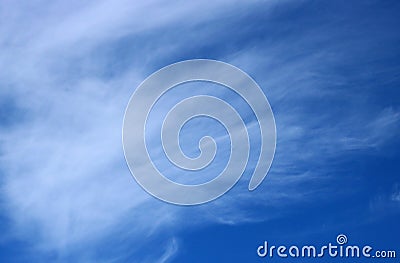 Thin wispy cirrus clouds seen against blue sky Stock Photo