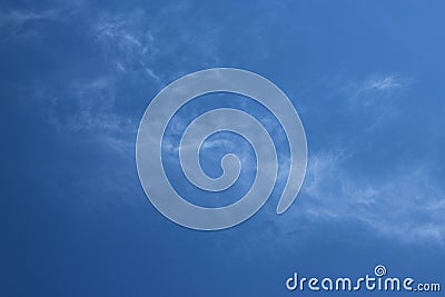 Thin wispy cirrus clouds seen against blue sky Stock Photo