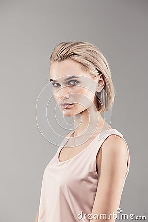 Thin young lady looking serious during photoshoot Stock Photo
