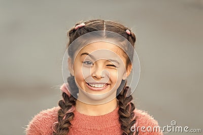 Things gonna be alright. Girl wink cheerful face grey background. Kid girl cheerful satisfied with everything. Cheerful Stock Photo