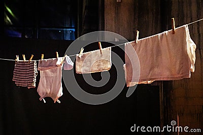 things hang on a rope on clothespins and dry on a sunny day. Stock Photo
