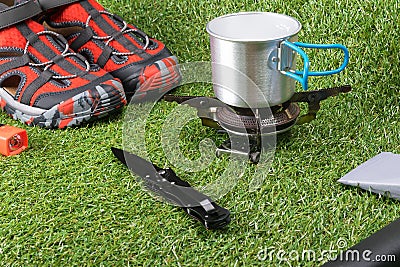 Things for hiking and recreation tourist in extreme conditions lie on the green grass Stock Photo