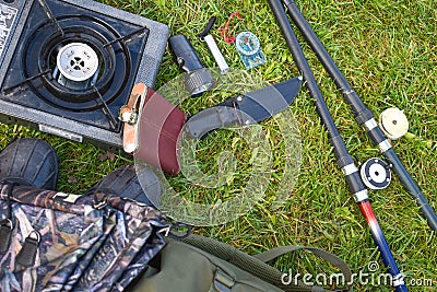 Things hunter on the grass. A necessary set of items for natural extreme travel. Editorial Stock Photo
