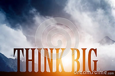 THINK BIG text on mountains landscape. Sunset sky, motivational Stock Photo