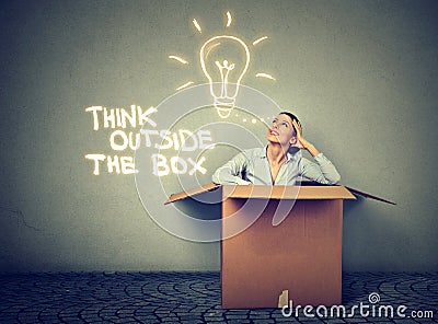 Think outside box. Woman coming out of box with great idea Stock Photo