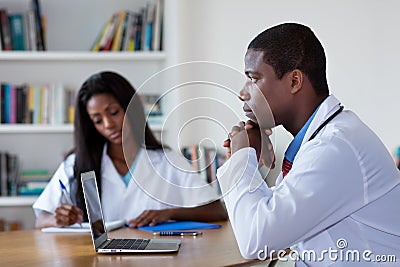 Thinking african american doctor with nurse Stock Photo