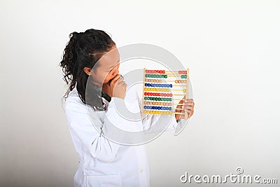 Thinking Asian scientist in lab coat counting on abacus Stock Photo