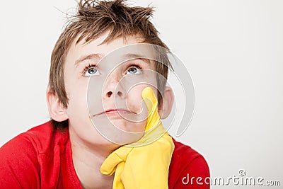 Thinking child with rubber gloved finger on chin Stock Photo