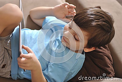 Online training education and communiction. Quarantine. Tablet and boy studying remotely. Pandemic children busy at home Stock Photo