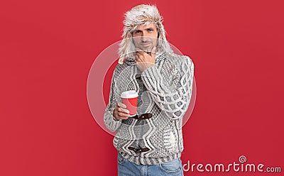 thinking hoary man drinking coffee. male fashion model hold cup. winter fashion. Stock Photo