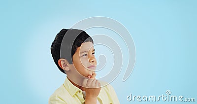 Thinking, inspiration and ideas, confused youth boy in studio with future or solution on blue background. Why, question Stock Photo