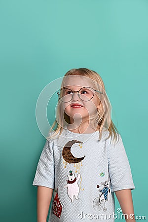 Thinking kid girl in glasses looking happy. Closeup instagram effect portrait Stock Photo