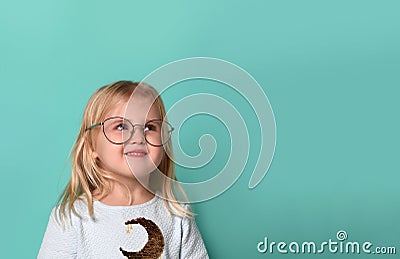 Thinking kid girl in glasses looking happy. Closeup instagram effect portrait Stock Photo