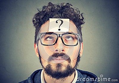 Thinking man with question mark looking up Stock Photo