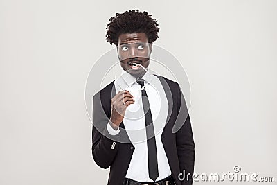 Thinking, pleased people. African businessman pondering and look Stock Photo