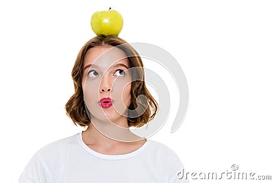 Thinking pretty caucasian woman holding apple on head Stock Photo