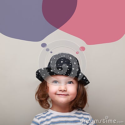 Thinking small kid dreaming about with big bubbles above Stock Photo