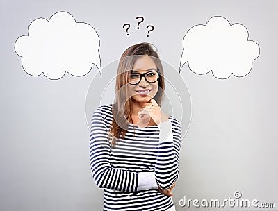 Thinking smiling young latina woman in business glasses with two Stock Photo