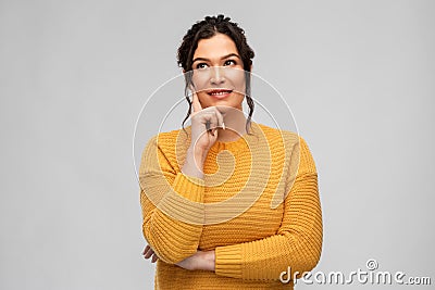 Thinking smiling young woman with pierced nose Stock Photo