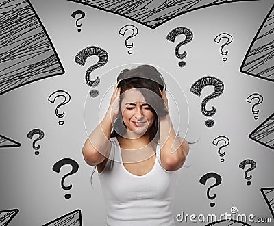 Thinking suffering concentrate unhappy with head pain and migraine woman holding the head with drawing questions sign above on gr Stock Photo