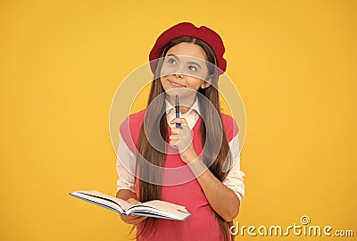 thinking teen school girl in french beret making notes in planner notepad or notebook, education Stock Photo