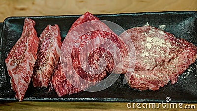 Thinly sliced Japanese wagyu beef on grille for barbecue. Yakiniku style Stock Photo