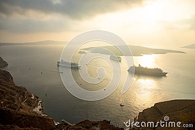 Thira, Santorini - 18.10.2018: Amazing evening view from Fira on cruise ships at sunset, Santorini, Greece Editorial Stock Photo