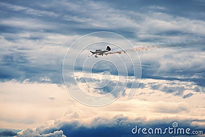 Third AirFestival at Chaika airfield. Small plane Yak-52 in storm clouds Editorial Stock Photo