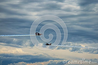 Third AirFestival at Chaika airfield. Two small red aircraft are flying towards. Thunderclouds at the background. Editorial Stock Photo