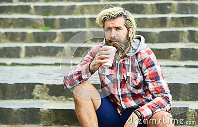 Third wave coffee culture. Man with beard drinking coffee. Bearded man drink coffee urban background. Hipster relax on Stock Photo