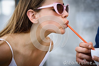 Thirsty for a drink. Cute woman drink through straw. Pretty woman sip beverage with drinking straw. Fashionable woman Stock Photo