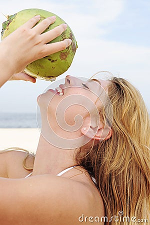 Thirsty woman drinking coconut water, close-up Stock Photo