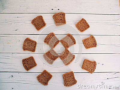 thirteen pieces of bread lie on white boards Stock Photo