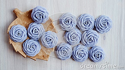 Thirteen pieces gray handmade rose flowers on white wood table Stock Photo