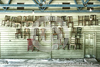 Thirty Hanging Chairs and a Door Stock Photo
