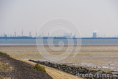 Tholen beach with view on the industrial zone, Bergse diepsluis, Oosterschelde, Zeeland, The Netherlands Stock Photo