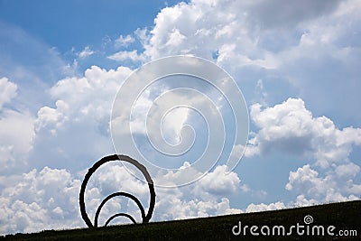 Thomas Sayre`s `Gyre` sculpture silhouetted against dramatic clouds Editorial Stock Photo